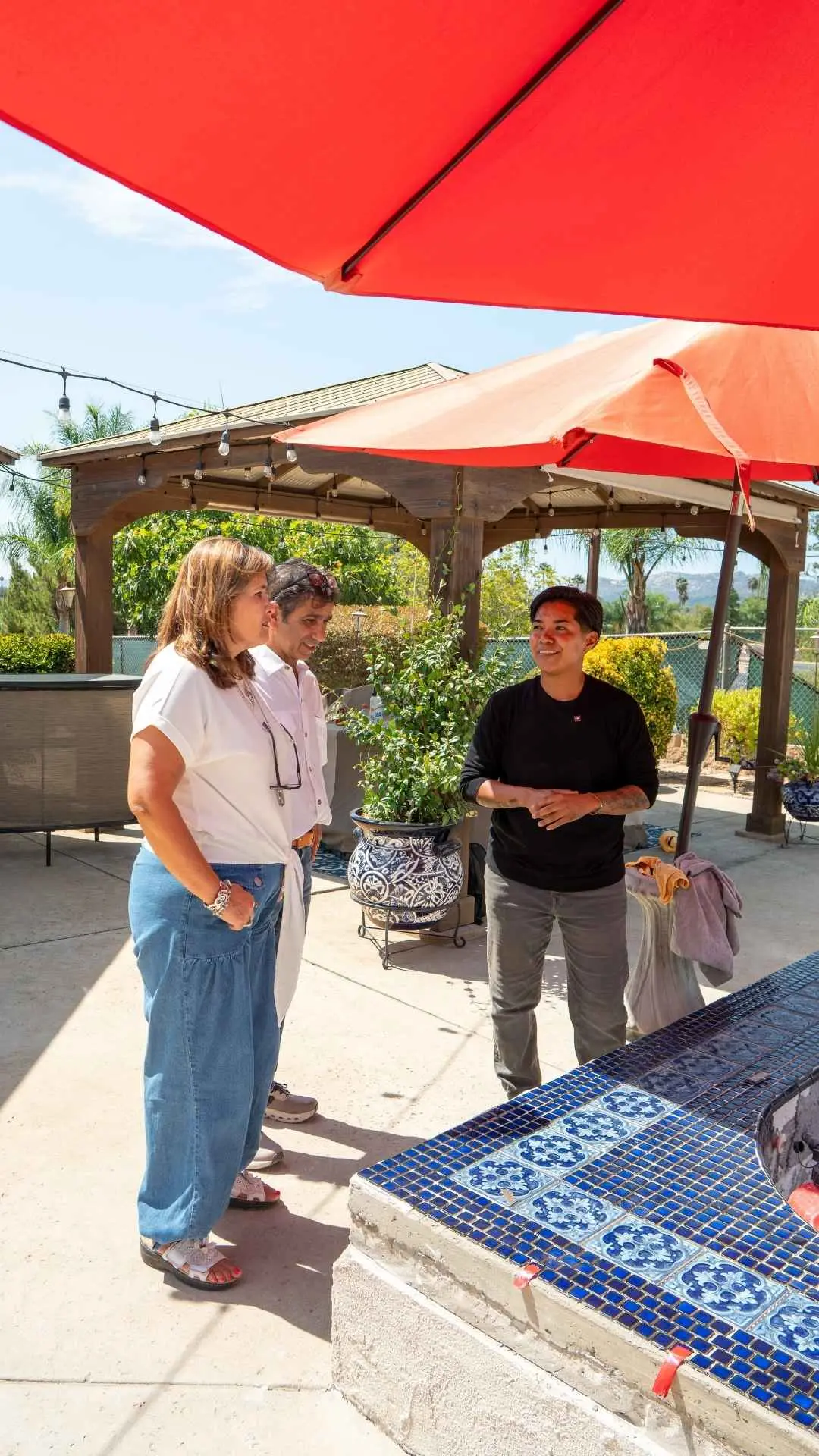 Jazmin Aguas walking a client through a pool project in Escondido