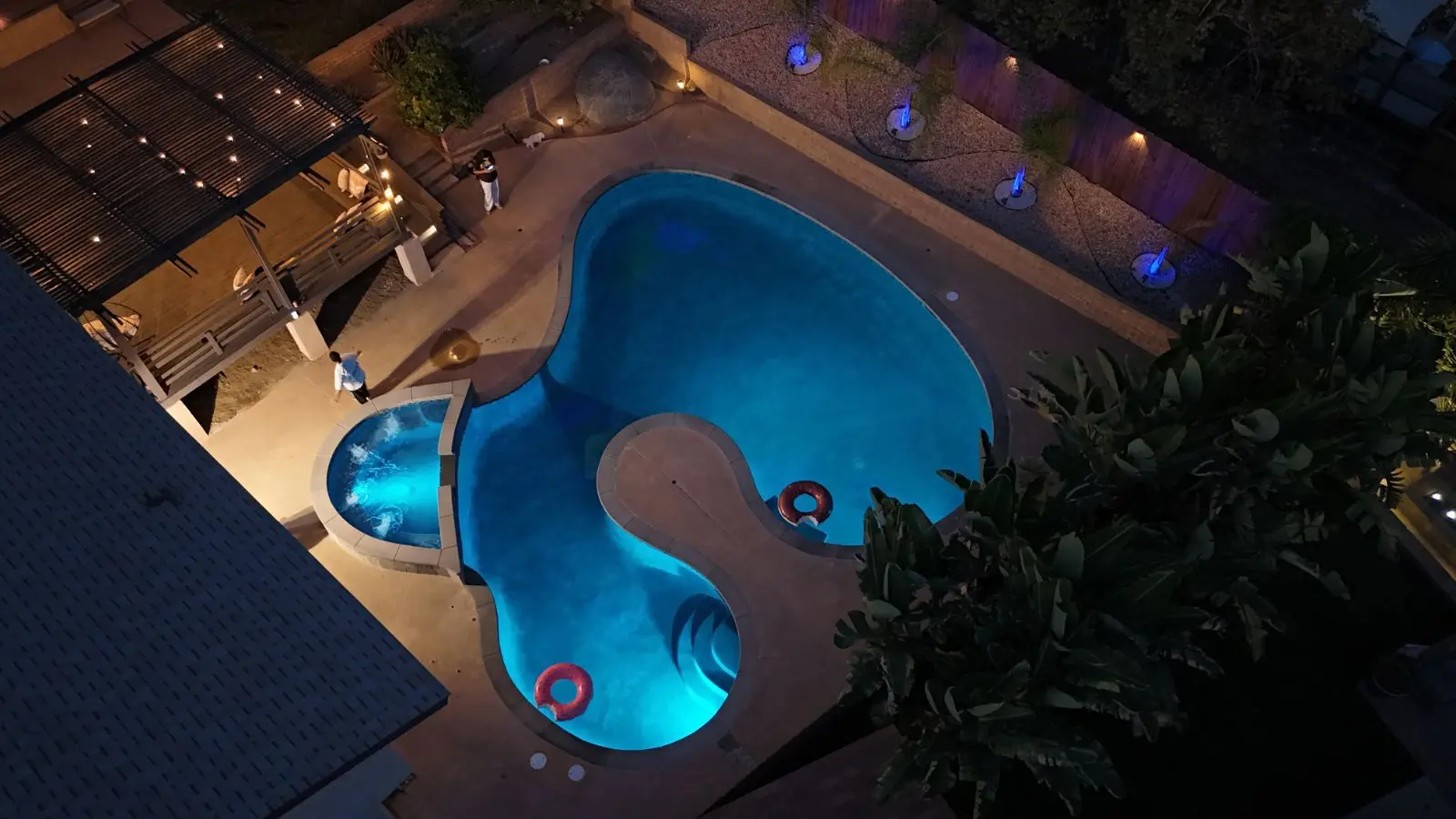 Finished figure-8 pool and spa lit at night in Escondido, CA