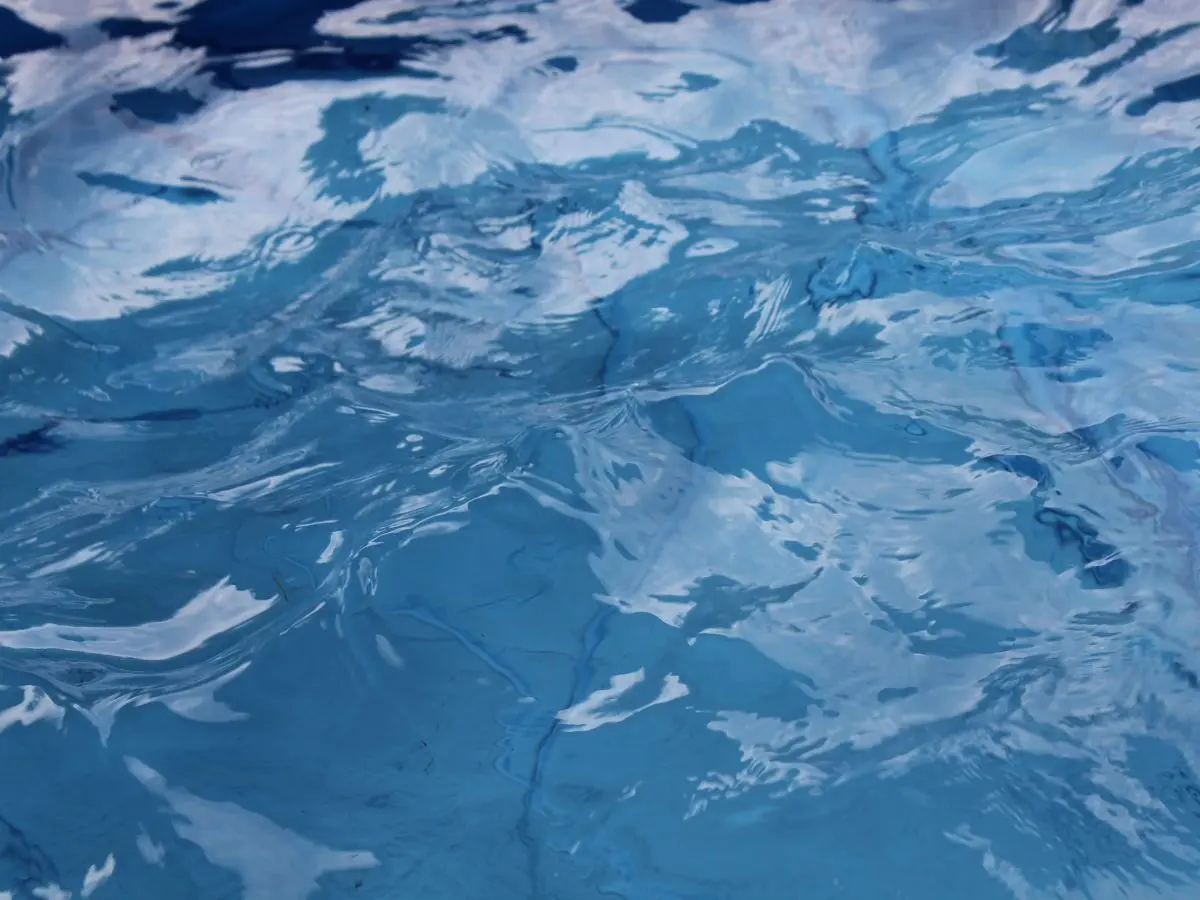 Clear pool water surface in a salt water system pool